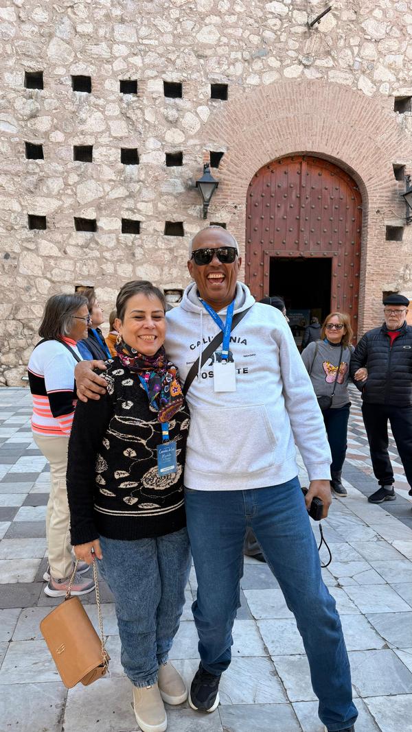 Grand Tour Andino, casal posa em frente a entrada de pedra antiga